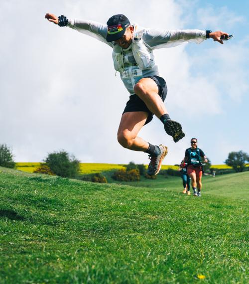 Brighton trail marathon runner jumps in the air 
