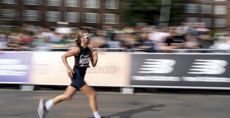 Person running in the Big Half with a blurred background.