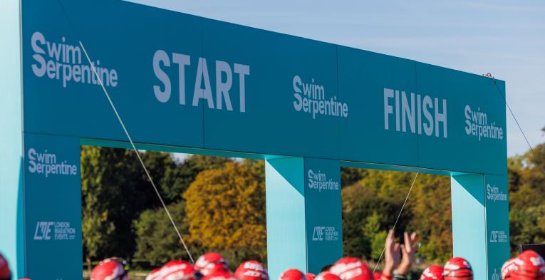 The start line of the Swim serpentine event with a row of heads in swimming caps in the bottom of the image.