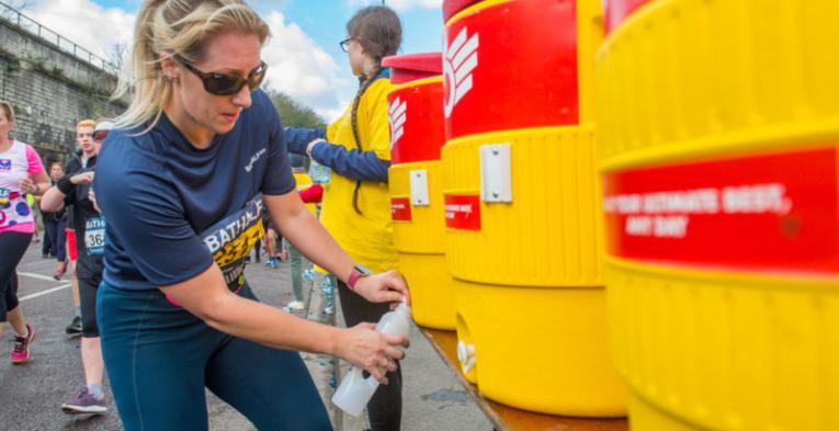 A lady re-fuelling her water bottle with water