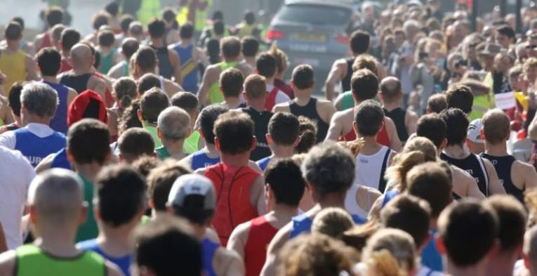 Lots of people jogging through Bath on a misty afternoon