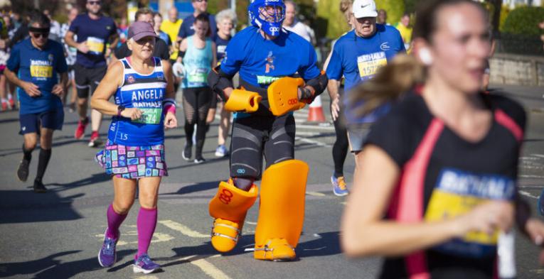 A man running the Bath Half in an ice hockey outfit.