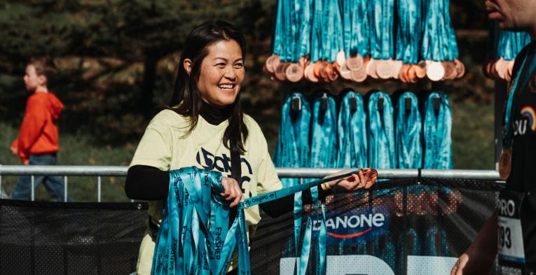 GetPRO Bath Half volunteer handing out medals