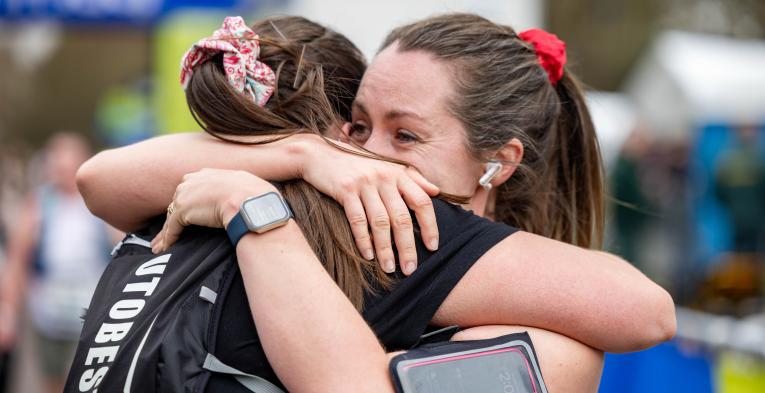 Participants hug each other