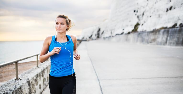 Woman running along the seafront in Brighton