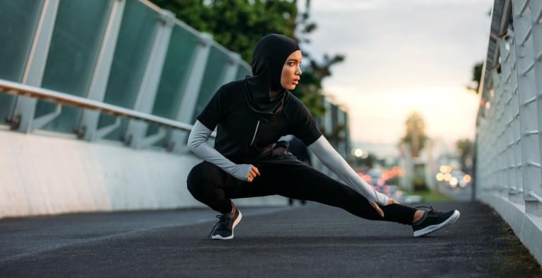 Woman stretching on a bridge before exercising