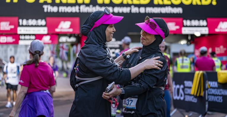 Participants embrace at the Finish Line of the 2025 TCS London Marathon
