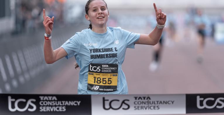 Jessica Thake celebrates as she crosses the finish line to win the U13 Girls race during the TCS Mini London Marathon Championships 