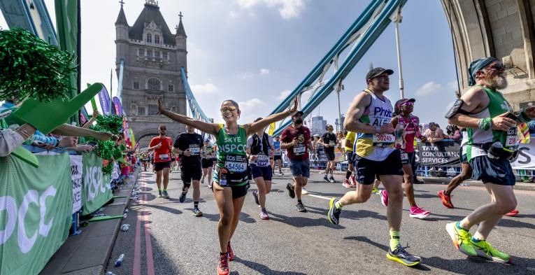 Participants running across Tower Bridge