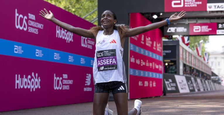 Tigst Assefa reacts as she crosses the Finish Line