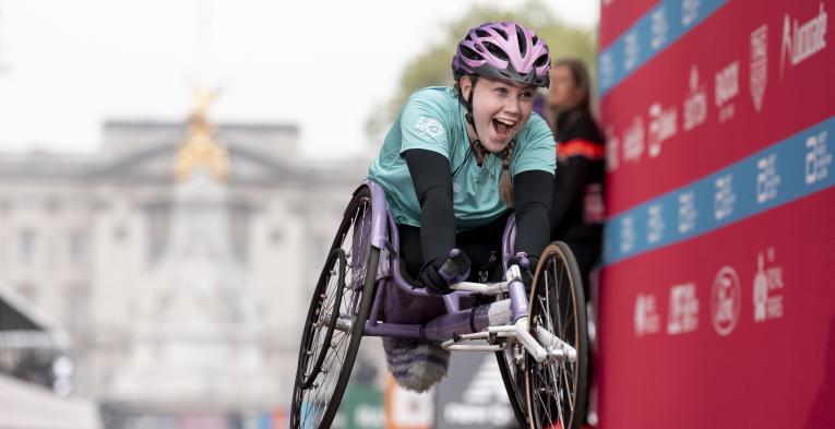 Niamh Currie, U17 Women Wheelchair winner, crosses the Finish Line
