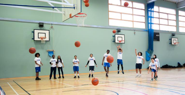 Young people shooting hoops for the Jr. NBA 3v3 launch 