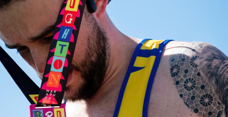 Volunteer putting a medal on a participant