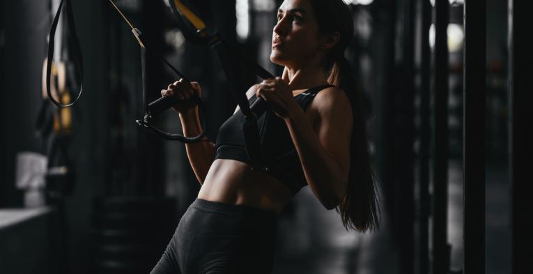 Woman TRX training in the gym