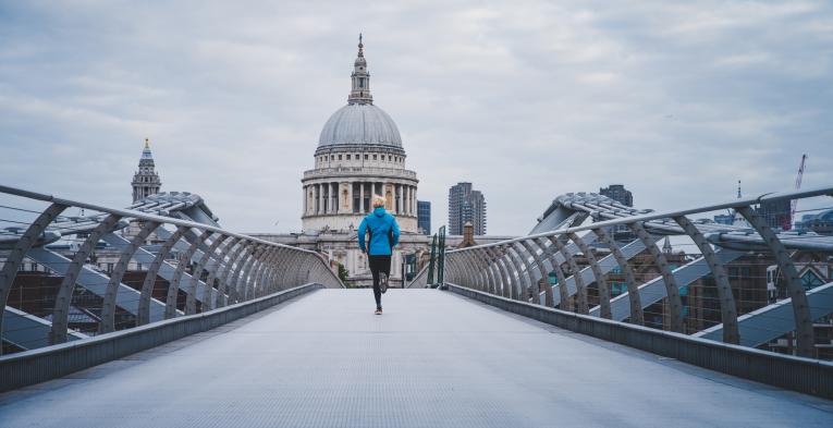 Runner crossing the Millennium Bridge