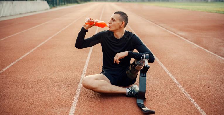Adaptive athlete sits down to have a drink