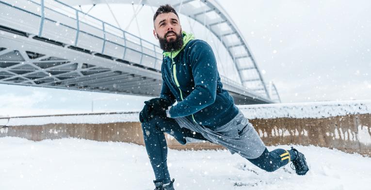 Runner training during winter out in the snow