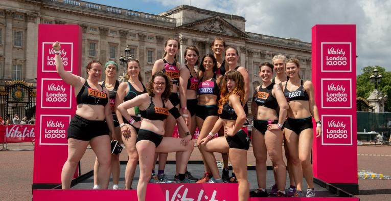 The Celebrate You Campaign group of runners pose for a picture on the podium outside Buckingham Palace