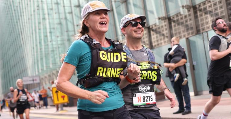 A blind runner and their guide at The Big Half