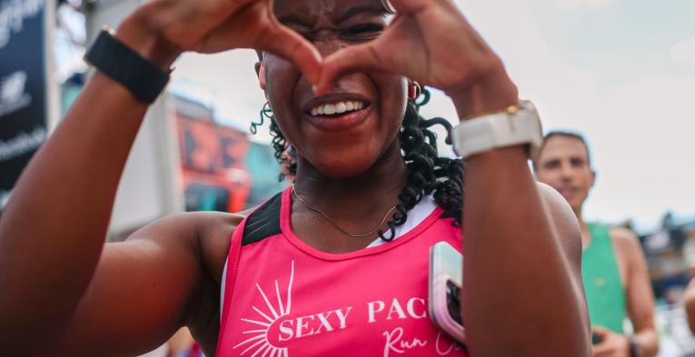 Runner making a heart with their hands at the Finish 