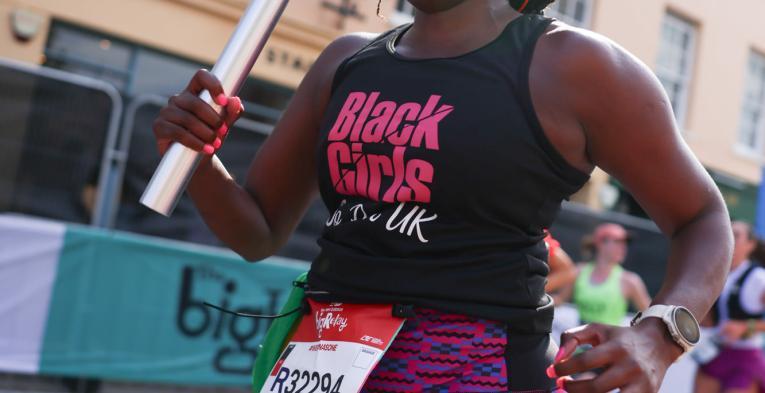 Big Relay participant carrying a baton 