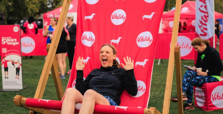 Runner poses in a giant deck chair at the Wellness festival
