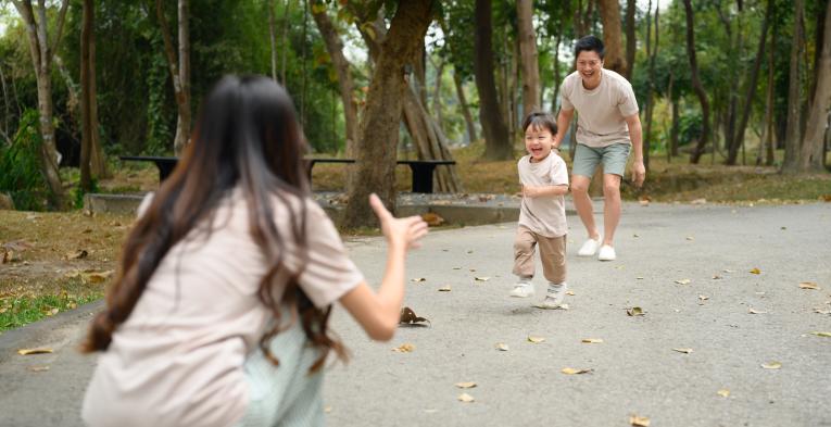 Son running towards his mother in the park