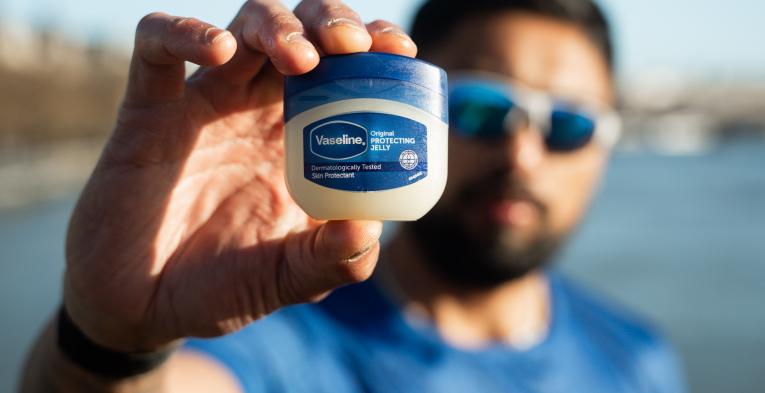 Runner holds up a mini tub of Vaseline
