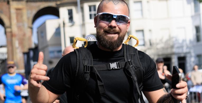 Man poses for the camera mid-run