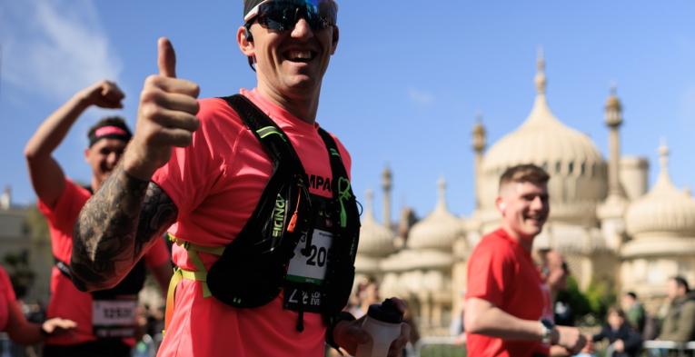 Runners give the camera a thumbs up
