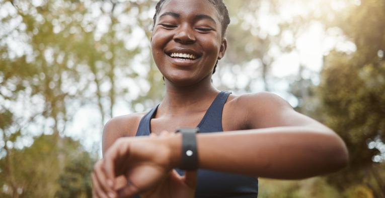 A runner glances down at their running watch 