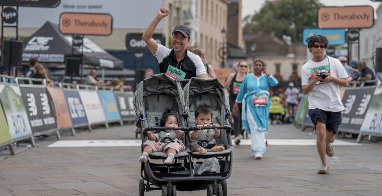 Man with a pram runs the Big Mile