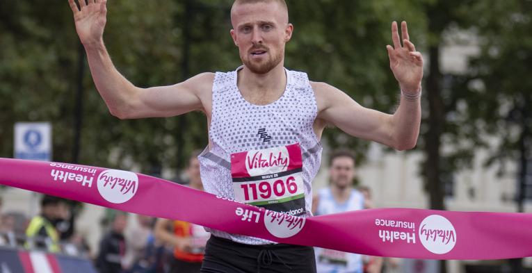 Joe Wigfield celebrates crossing the finish line on the Mall in first place during the British Milers Club Bannister Mile 