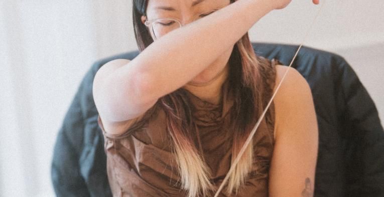 Nicole Chui stitching a bespoke piece 