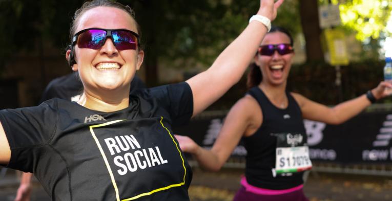 Runners throw their hands in the air in celebration 