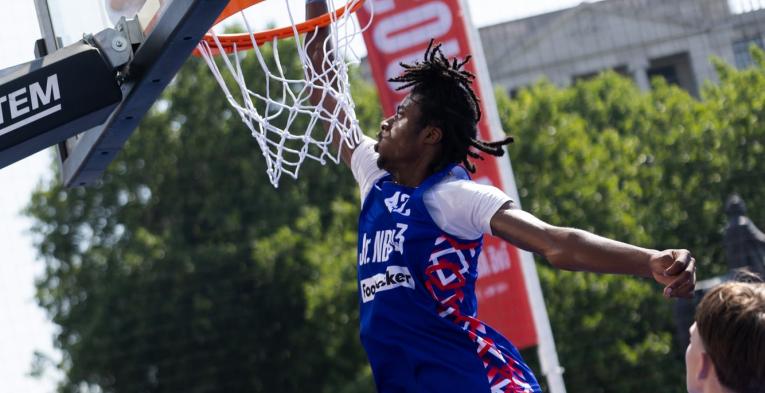 Jr NBA player going for a slam dunk 