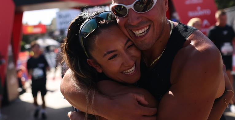 Two Big Half participants hug after crossing the Finish Line