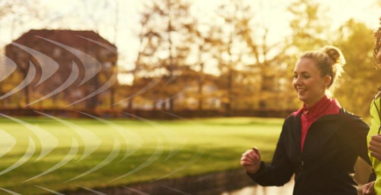 Two friends partner up for a training run in the park