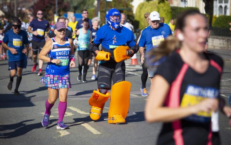A man running the Bath Half in an ice hockey outfit.