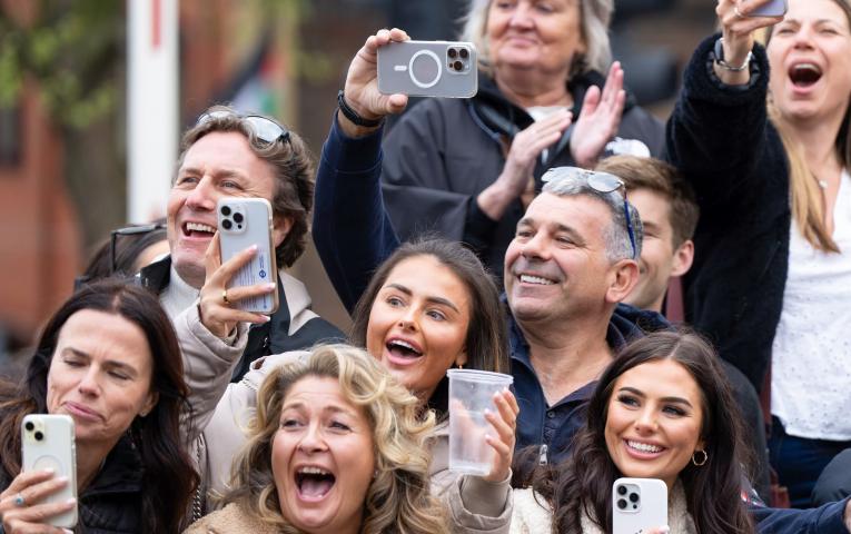Friends and family watching their loved ones run