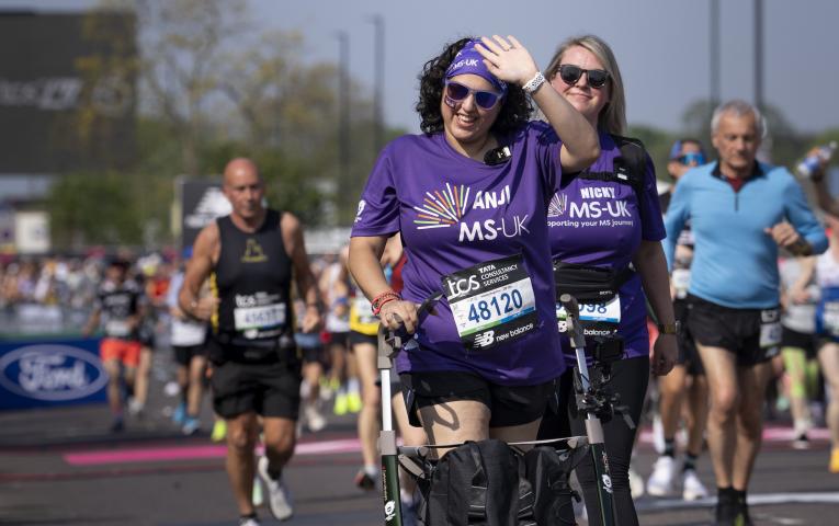 A participant using a frame walker leaves the Start Area 