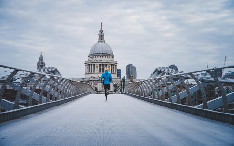 Runner crossing the Millennium Bridge