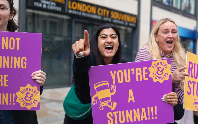 Supporters cheer on runners