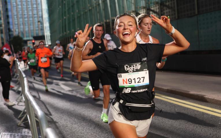Big Half runner throws a double peace sign for the camera