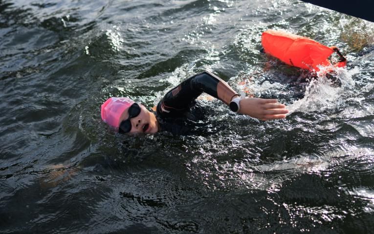 Swimmer passes under the Finish 