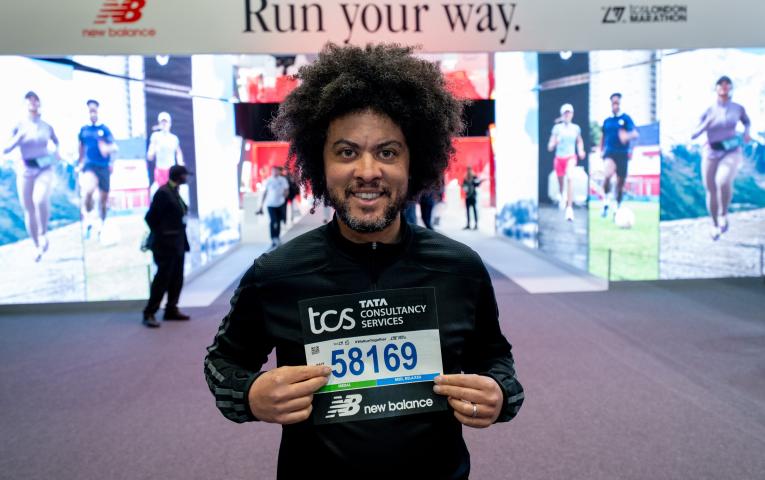 A runner collecting their number at the TCS London Marathon Running Show