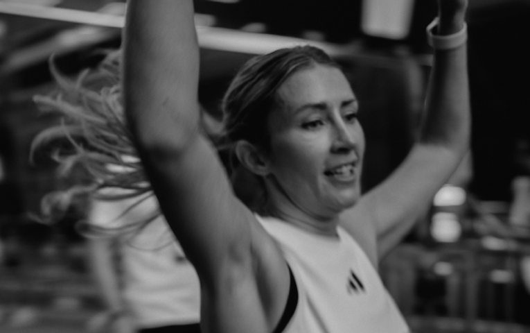 Runner throwing their arms in the air 