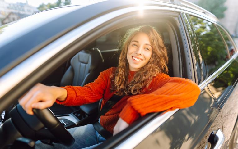 Woman posing for the camera from the drivers seat 