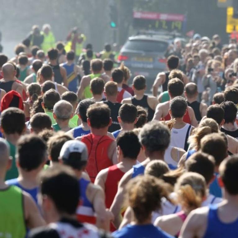 Lots of people jogging through Bath on a misty afternoon