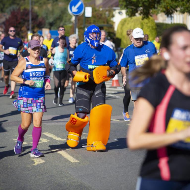 A man running the Bath Half in an ice hockey outfit.